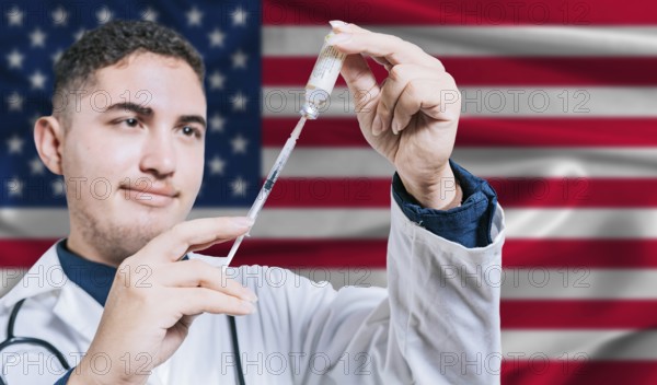 Doctor holding syringe on United States flag background. Medical professional holding syringe with American flag in the background