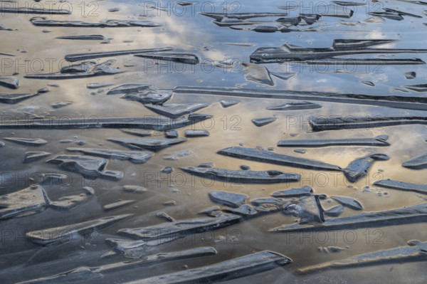 Pieces of ice and clouds reflecting on the water surface, lake, winter, Finland