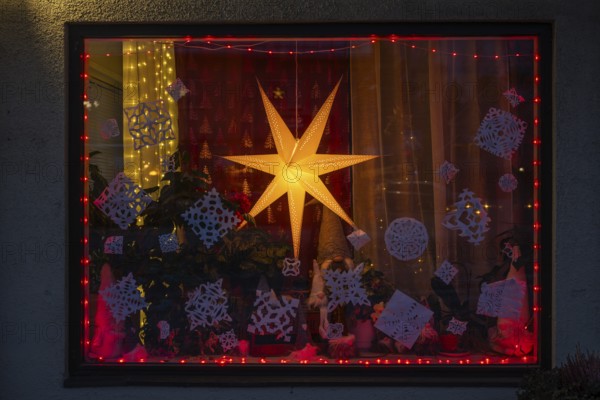 Christmas decorated and illuminated shop window with Christmas stars and fairy lights, Sysmä, Finland