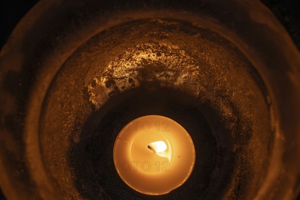 Burning tea light in a bowl of ice, winter, Finland