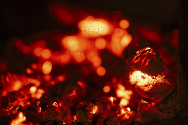 Glowing wood from a burning fireplace, log, embers, fire