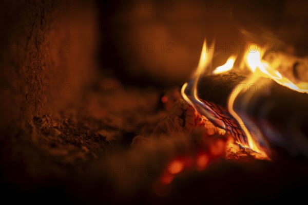 Burning wood, log, embers, fire in a fireplace