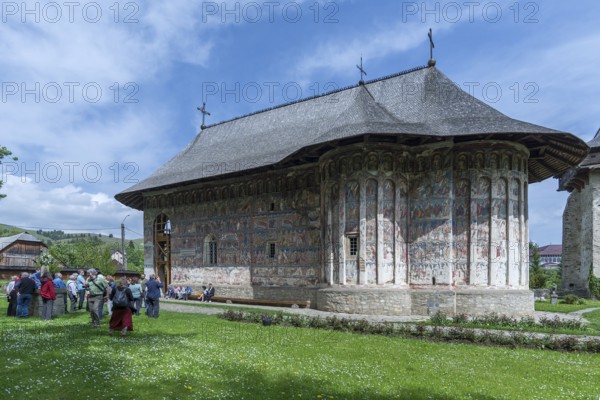 Tour group in front of Humor Monastery, Romanian Orthodox Women's Monastery, 1530, Gura Humorului, Romania