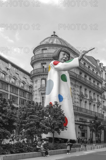 Gigantic figure by Japanese artist Yayoi Kusama pointing at Louis Vuitton department store, black and white, Paris, France