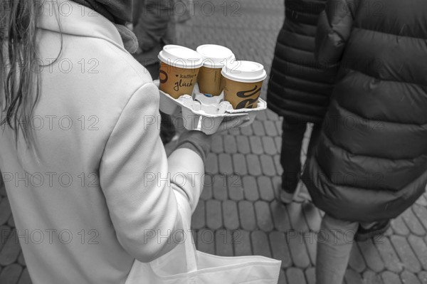 Lady carrying three coffees to go on the street, black and white, Nuremberg, Middle Franconia, Bavaria, Germany