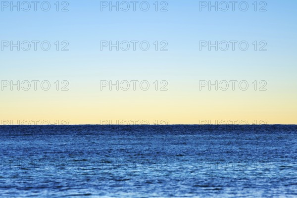 Minimalist illustration, horizon over the sea, clear evening sky, various shades of blue, calm water surface, background picture, seaside resort Mondello, Palermo, Sicily, north coast, Tyrrhenian Sea, Italy