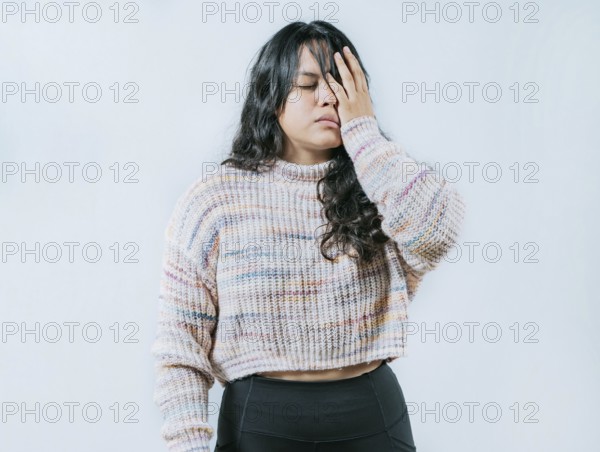 Exhausted young woman putting the palm on his face isolated. Tired and exhausted person covering his face with the palm of hand