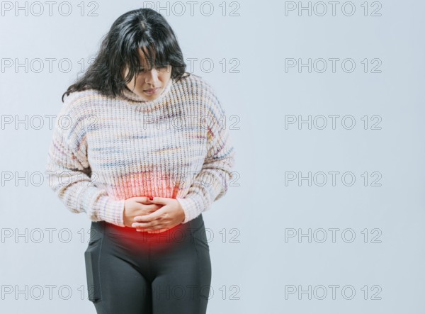 Female person holding stomach with digestive problems isolated. Sore Asian woman with digestive problems
