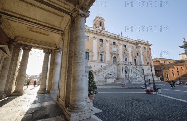 Arcade, columns of the Palazzo Nuovo in the morning light, Senators' Palace (Palazzo Senatorio) in the background, Piazza del Campidoglio on the Capitoline Hill, Capitoline Square, Rome, Lazio, Italy