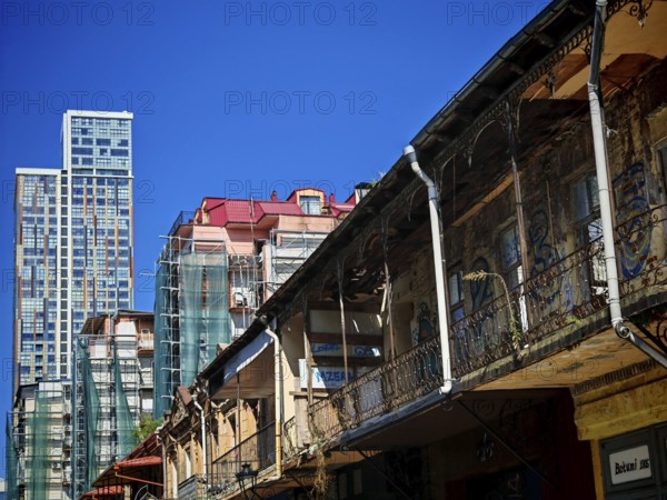 Modern and old architecture contrasting under clear skies, Batumi, Georgia