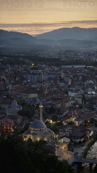 A view of the city at dusk dominated by a mosque and surrounded by mountains, Prizren, Kosovo