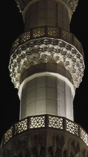 Detailed view of an illuminated minaret with intricate ornaments at night, Tirana, Albania
