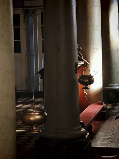A quiet church interior with tall pillars and a hanging incense barrel in a play of light, Franconian Forest