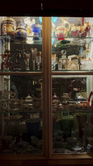 Showcase with illuminated decorative glassware and antiques, Prague, Czech Republic