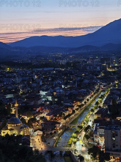 Nighttime city view with illuminated river and adjacent architecture, Prizren, Kosovo