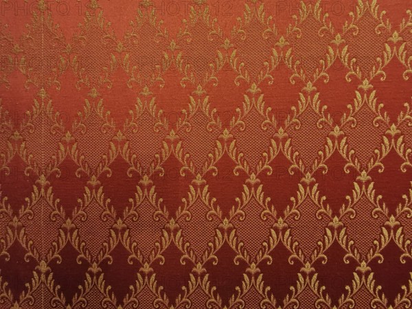 Red fabric with golden, ornamental damask pattern