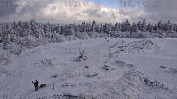 Snowy landscape with a wide view under blue, cloudy sky. Lonely and quiet, Schneeberg, Fichtelgebirge, Bavaria