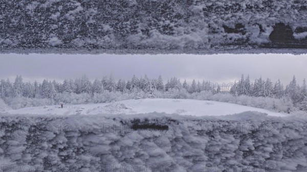 Snowy landscape with views of a forest from the viewpoint. Quiet, cold atmosphere, Schneeberg, Fichtelgebirge, Bavaria