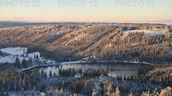 View of a snow-covered forest and lake during sunset, Rennsteig, Thuringian Forest