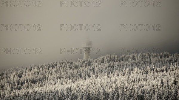 Snowy forests with a tower disappearing in fog, view from Nusshardt towards Bacöfele Schneeberg, view from Nusshardt towards Bacöfele on Schneeberg, Fichtelgebirge, Bavaria