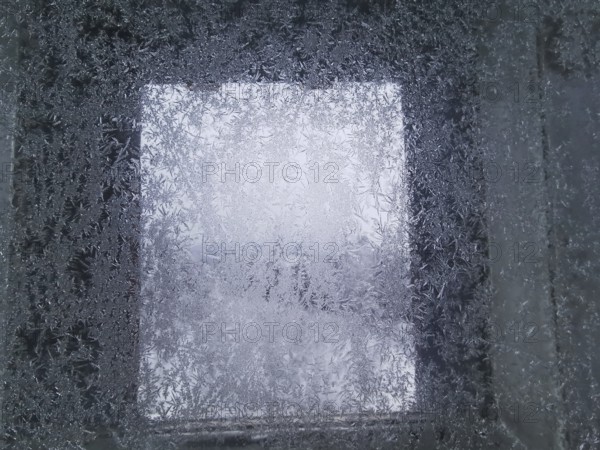 An icy window with frosty structures that give off a cold winter feeling, Franconian Forest nature park Park
