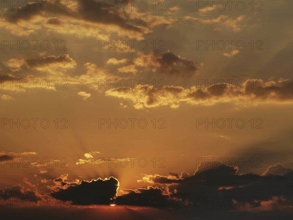 Dramatic sunset with glowing clouds and rays