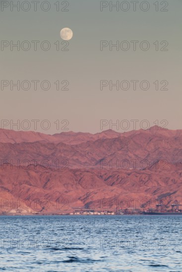 Eilat, Israel, Middle East. From across the red sea in Eilat Aqaba in Jordan on the opposite side of the bank during a full moon
