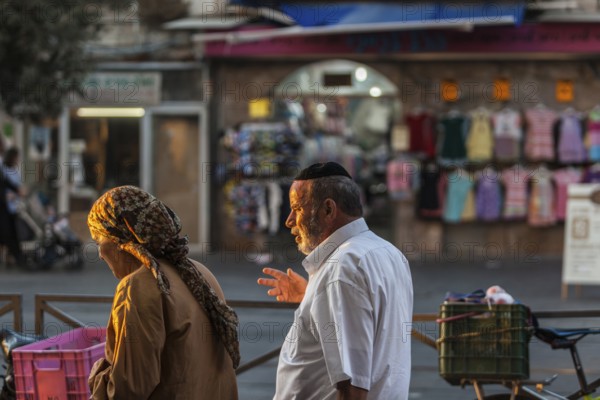 Jerusalem, Israel, Middle East. A couple walking in the Mea Sharim district in Jerusalem