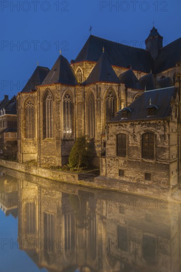Ghent, Belgium, Flanders. A historic church with reflections in a canal