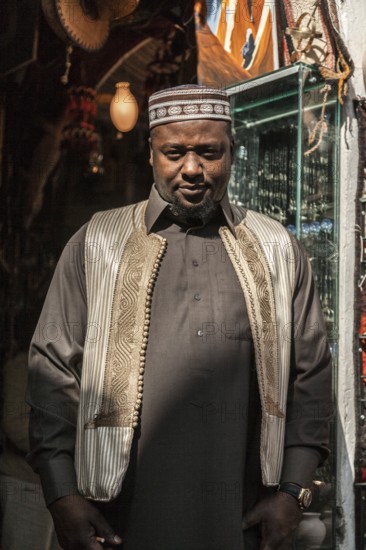 Misurata, Libya, North Africa. A Libyan man from one of the numerous desert tribes in his shop in the Italian influenced town in the desert