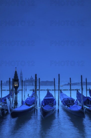 Venice, Veneto, Italy. Gondolas on the bacino di San Marco with San Giorgio Maggiore in the background