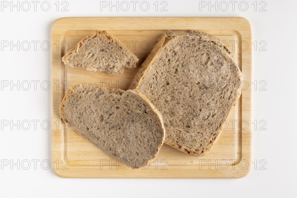 Wooden board with several slices of bread