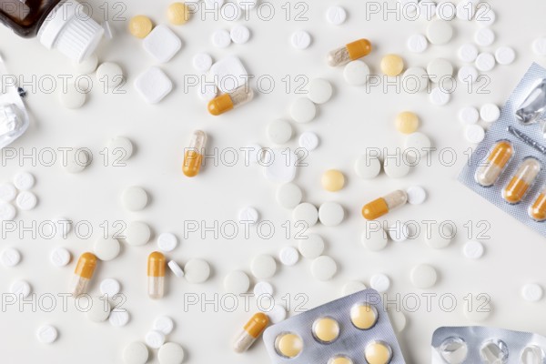 Different tablets and blister packs on a bright background