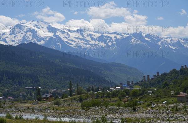 Mountain landscape with snow-capped peaks and a small village in the valley, Mestia, Mingrelia and Upper Svaneti, Svaneti, High Caucasus, Georgia