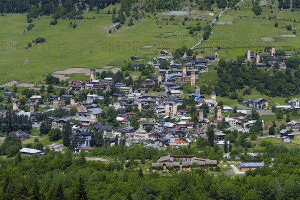 A village with scattered old houses in a green mountain landscape, defensive towers, Mestia, Mingrelia and Upper Svaneti, Svaneti, High Caucasus, Georgia