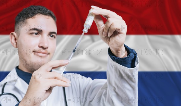 Doctor holding syringe on Netherlands flag background. Medical professional holding syringe with Dutch flag in the background