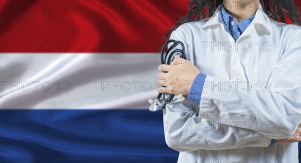 Healthcare professional with Netherlands flag background. Professional doctor holding stethoscope on Netherlands flag background