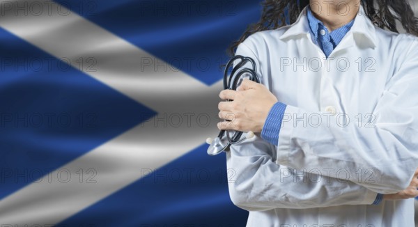 Healthcare professional with Scotland flag background. Professional doctor holding stethoscope on Scotland flag background