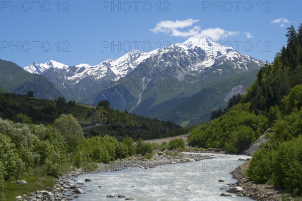 Fast-flowing river in a wooded valley against a backdrop of snow-capped mountains, Mulkhra River near Artskheli, Mulkhura, Mingrelia and Upper Svaneti, Svaneti, High Caucasus, Georgia