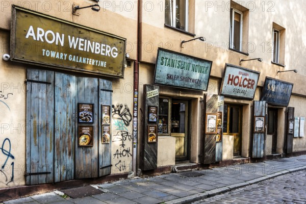 Shop fronts on Szeroka Street, signs bearing Polish and Jewish names, Kazimierz, a historically significant, formerly independent district that has developed into an important center of Jewish culture since the 14th century, Krakow, Poland