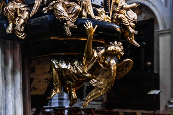 Richly decorated pulpit with intricate golden carvings, angel on the pulpit has symbolic meaning and serves as an announcing figure, by Antoni Frackiewicz, St. Anna Church in Baroque style, 1381, Krakow, Poland