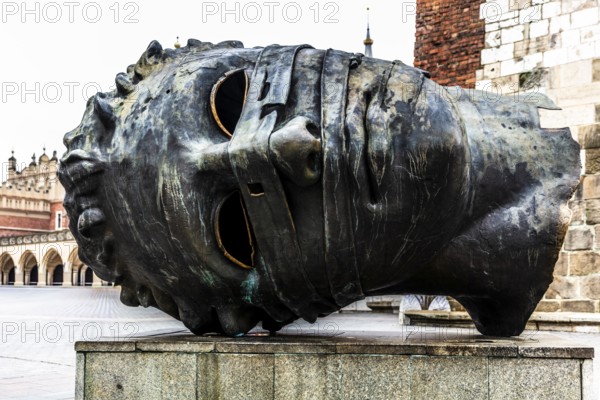 Eros Bendato, modern bronze head, rynek with cloth halls, from 13th century, main market square, landmark of the city, Krakow, Poland