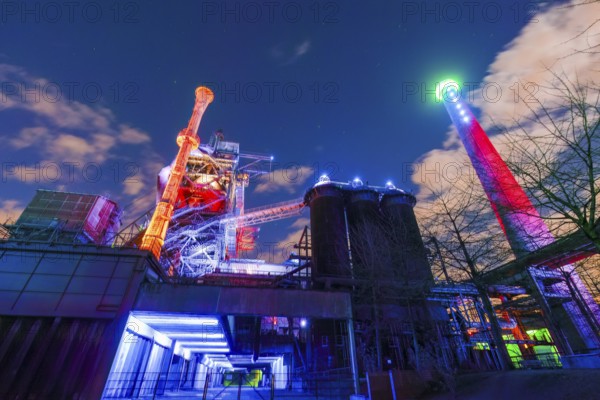 Bright and colorful lighting of an industrial plant at night, Landschaftspark Duisburg Nord, Duisburg, North Rhine-Westphalia, Germany