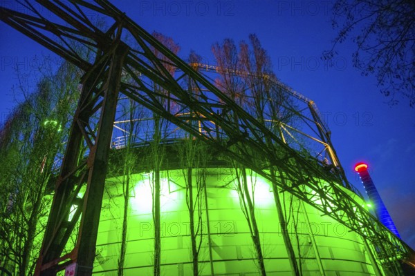Industrial building illuminated at night in green with steel structures, Landschaftspark Duisburg Nord, Duisburg, North Rhine-Westphalia, Germany