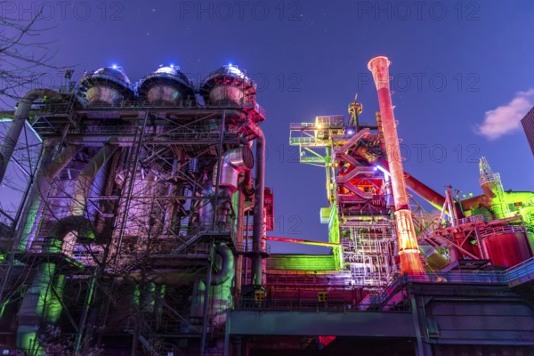 Factory complex in colorful, lively lights under the night sky, Landschaftspark Duisburg Nord, Duisburg, North Rhine-Westphalia, Germany