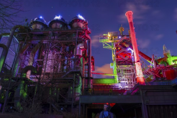Industrial plant illuminated in colorful lights at night, Landschaftspark Duisburg Nord, Duisburg, North Rhine-Westphalia, Germany