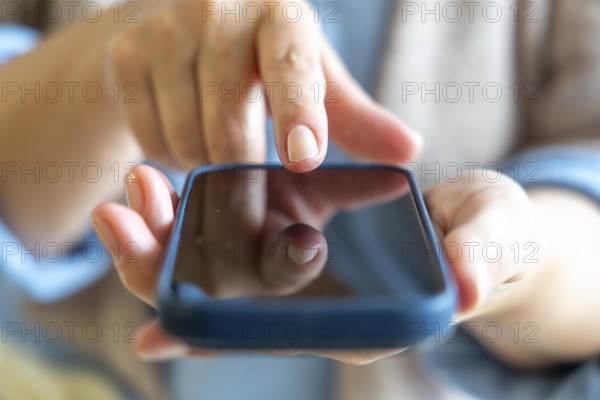 Cell phone, mobile phone, in the hand of a user
