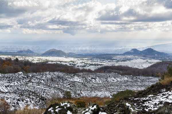 View from Silvestri Crater of dark hills with remnants of snow, barren volcanic landscape, Sartorius mountains, Etna, Etna, Catania, Sicily, Italy