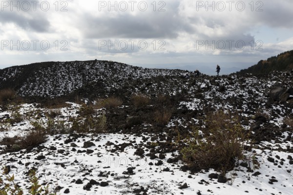 Barren volcanic landscape with remnants of snow, hikers, Etna, Etna, Catania, Sicily, Italy