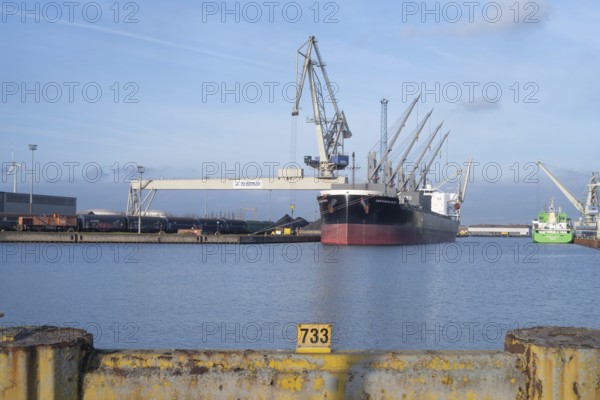 View across a harbor basin to the Huttenhafen industrial area in Bremen, Germany
